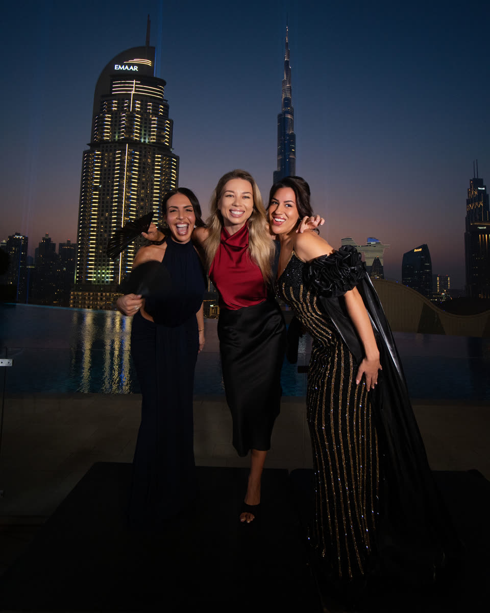 Guests of The Rallyes at dusk, with the Dubai skyline behind them