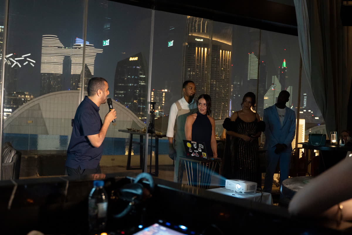 A talk at a Rally of The Rallyes, with the Dubai skyline behind the speaker