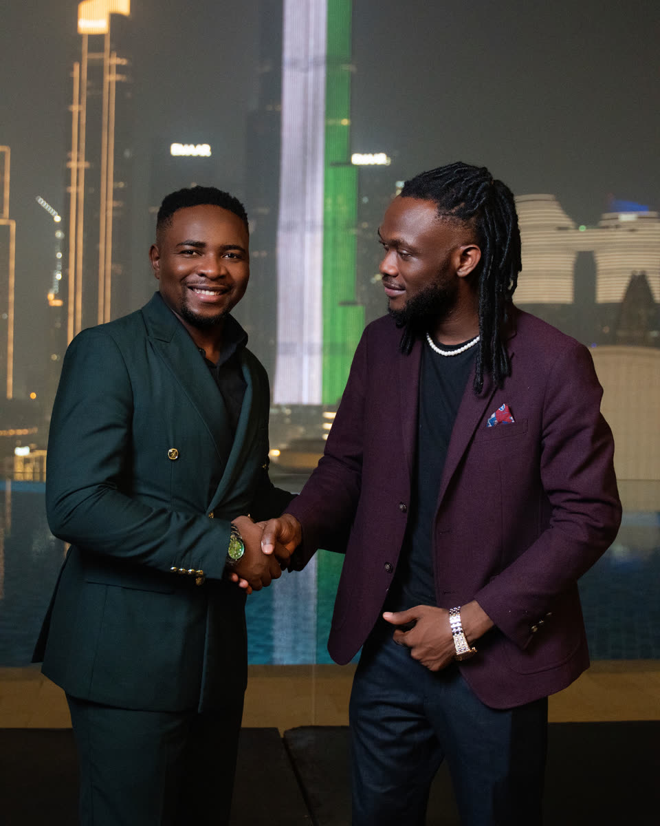 Two guests shaking hands on the terrace during Rally 001 in Dubai